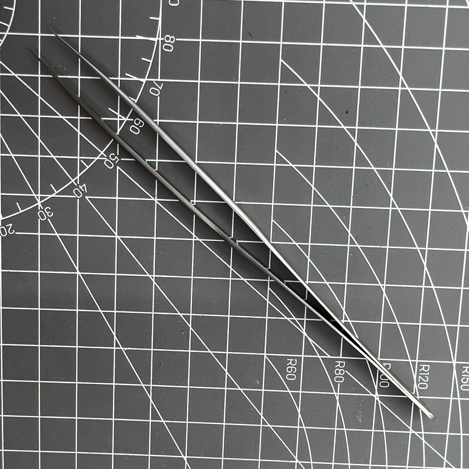 Swiss Made Bergeon 7027-SS tweezer with fine stainless steel tips for precise watch repair.