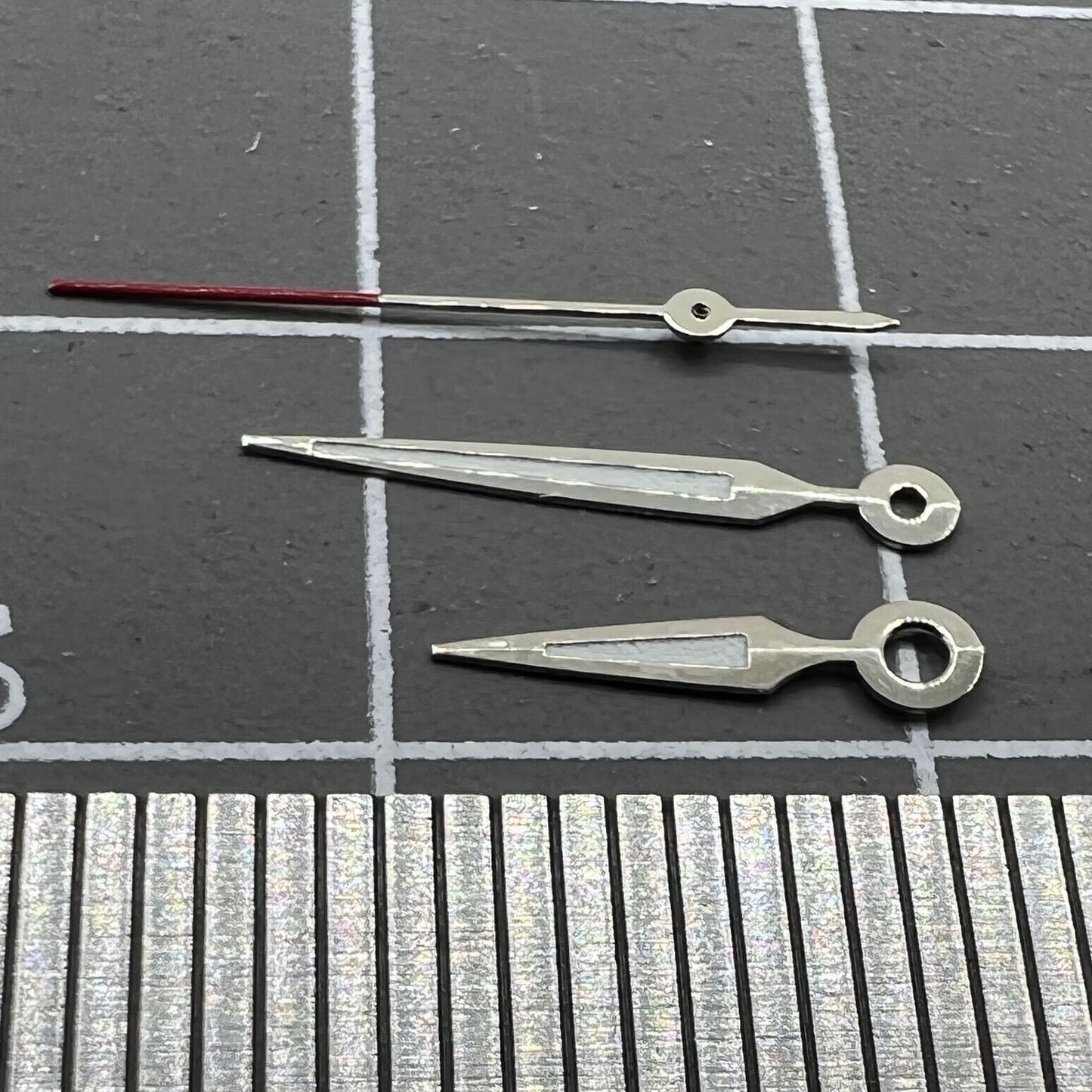 Luminous arrow-shaped watch hands by Miyota, perfect for enhancing visibility in low light conditions.