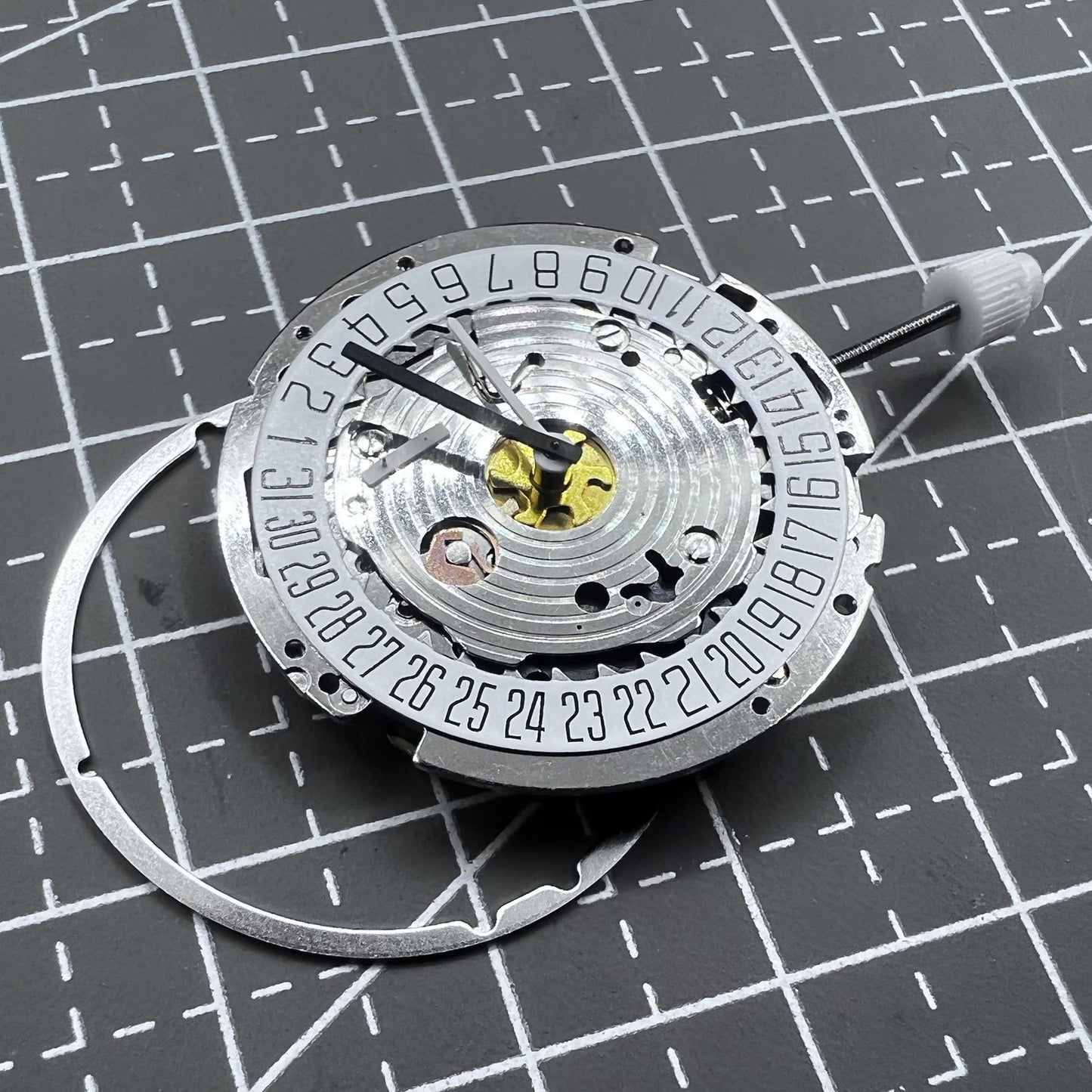 Swiss ISA 8171A quartz watch movement with white dial, four hands, and date at 6 o?clock for precise timekeeping.