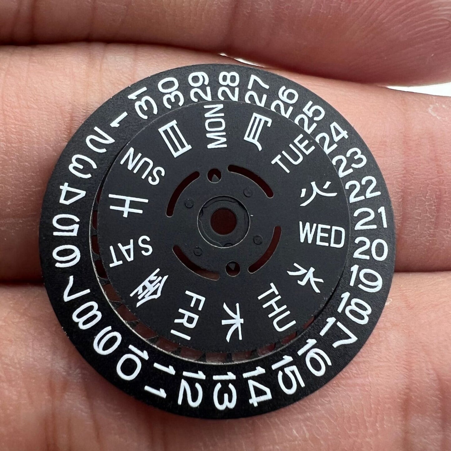 Blue and green lume date and week wheels for NH36 movement, black disk highlights date at 3.8 position.