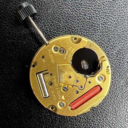 ETA F04.111 quartz watch movement showing three hands and date window, Swiss precision craftsmanship.