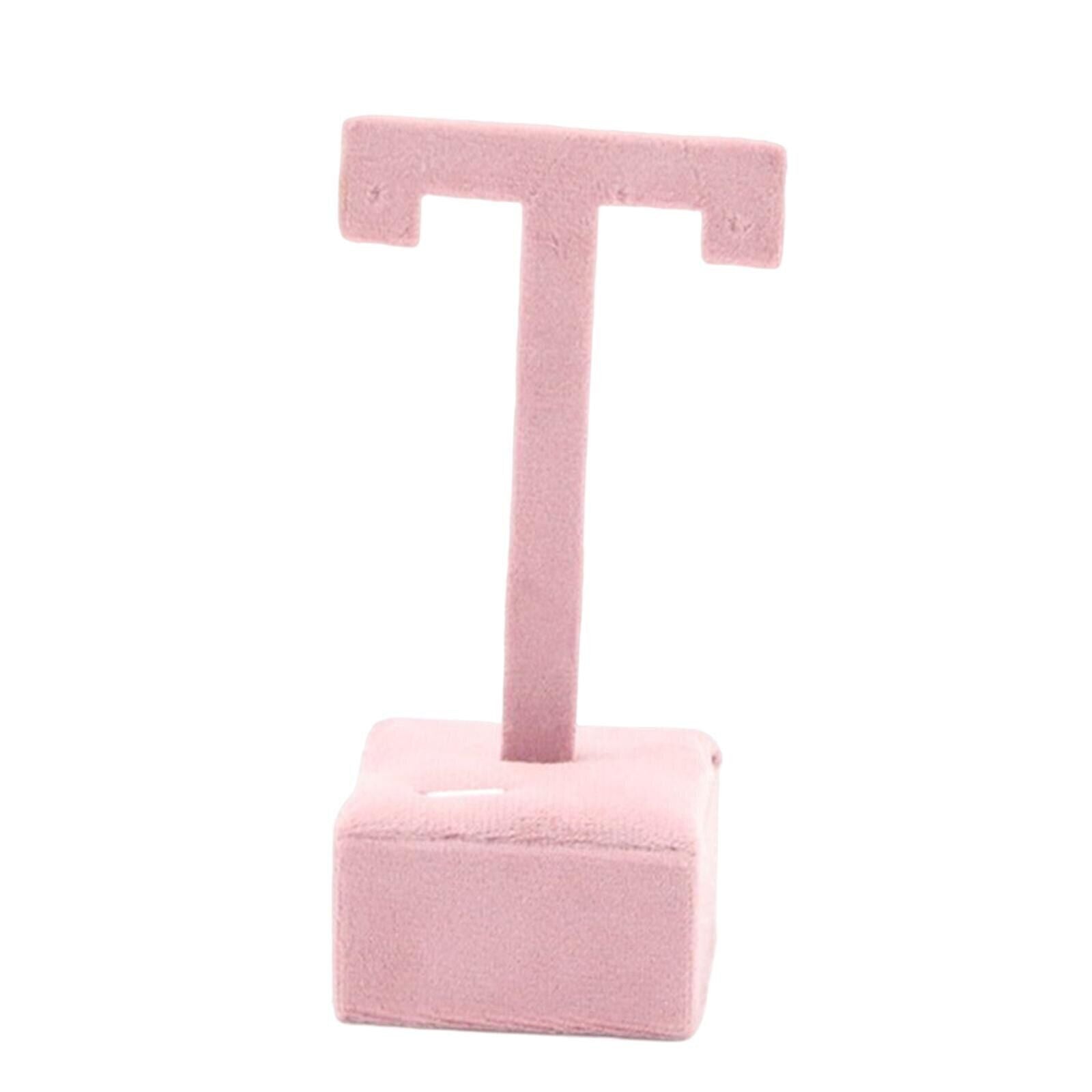 Earring display stand with hanging hooks and decorative shelf for organized jewelry storage.