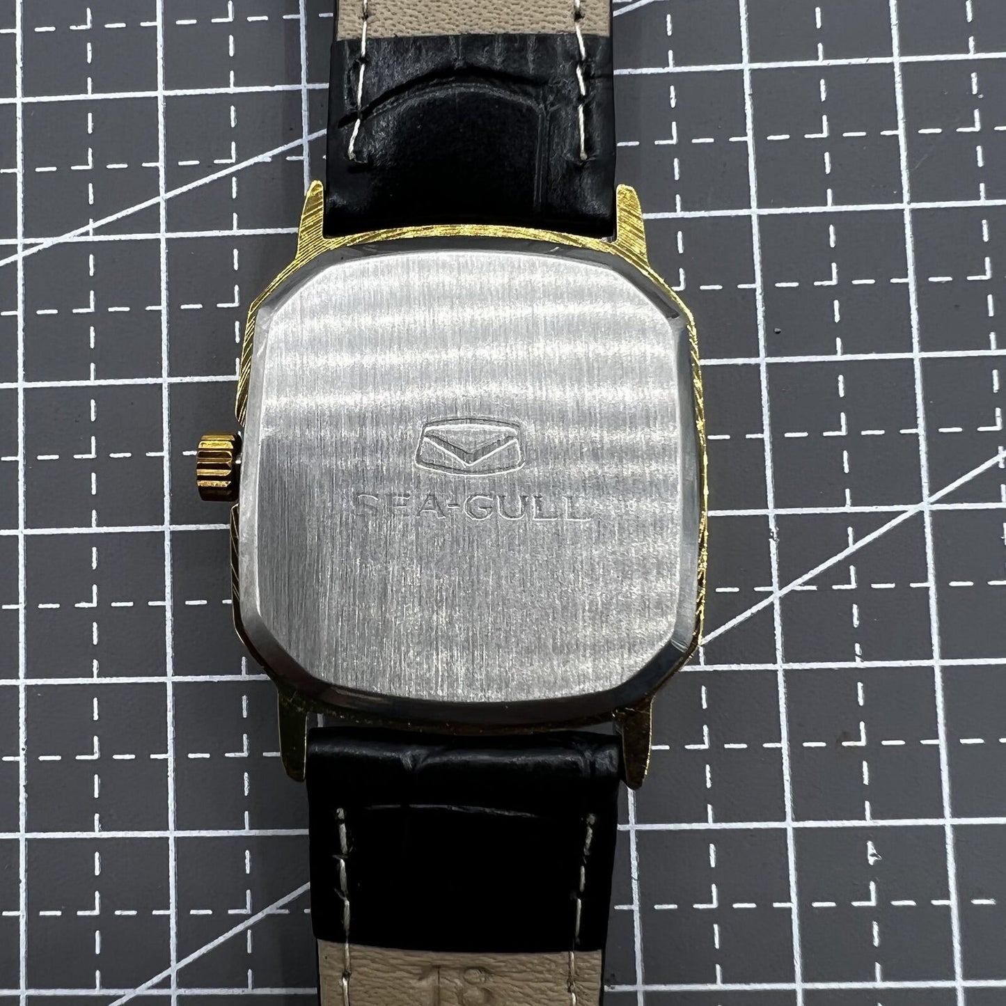 28mm Tianjin Seagull watch with octagonal gold case, golden dial, and manual mechanical movement.