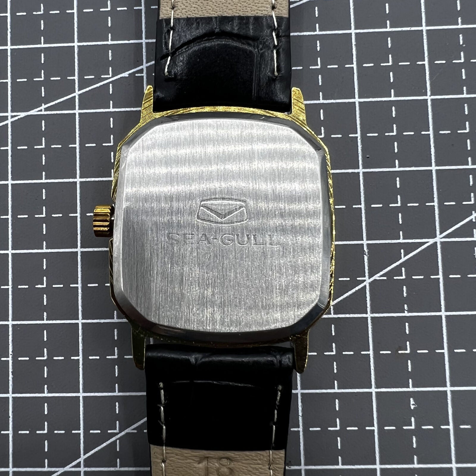 28mm Tianjin Seagull watch with octagonal gold case, golden dial, and manual mechanical movement.