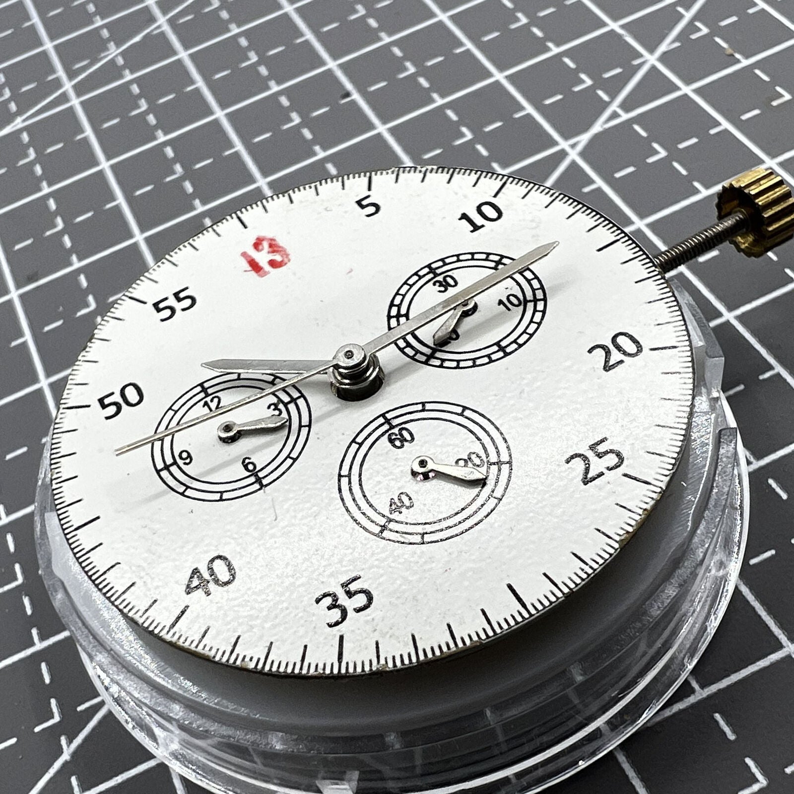 Dandong 7750 mechanical watch movement dial highlighting small seconds at 3, 6, and 9 o?clock, no calendar feature.