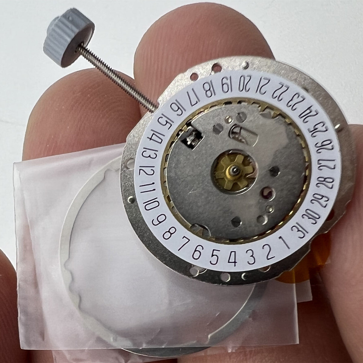 Golden silver-gilted Swiss RONDA 785 calendar quartz movement for precise watch accessory repair.