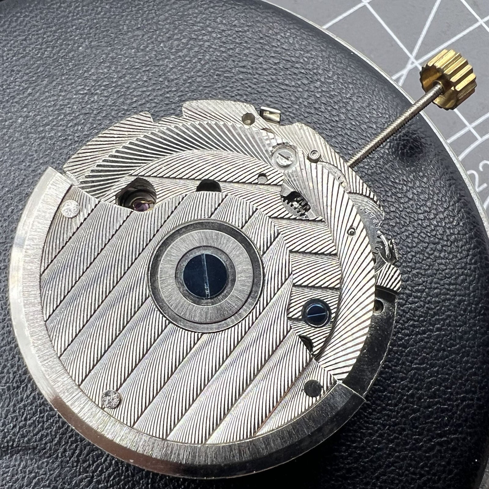 Automatic mechanical watch with reversed balance wheel, big date at 12, and intricate craftsmanship.