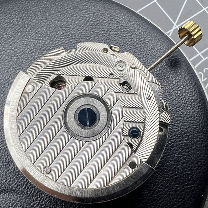 Automatic mechanical watch with reversed balance wheel, big date at 12, and intricate craftsmanship.