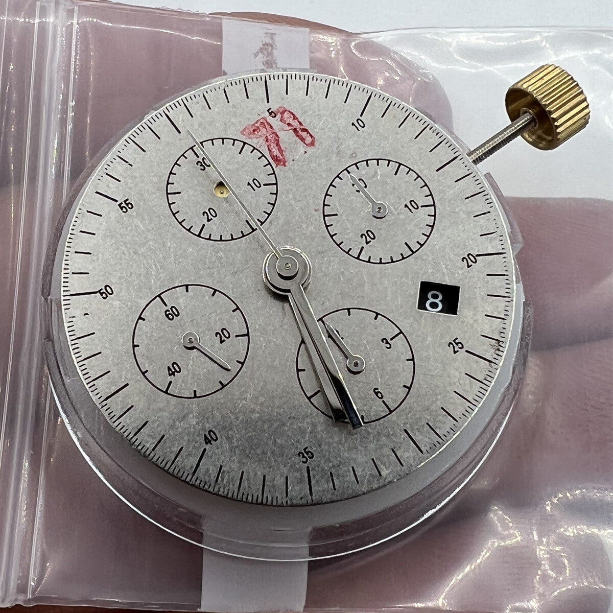 Black Dandong 7753 automatic watch with mechanical movement and small seconds at 9, China made.