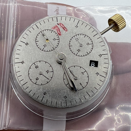 Black Dandong 7753 automatic watch with mechanical movement and small seconds at 9, China made.