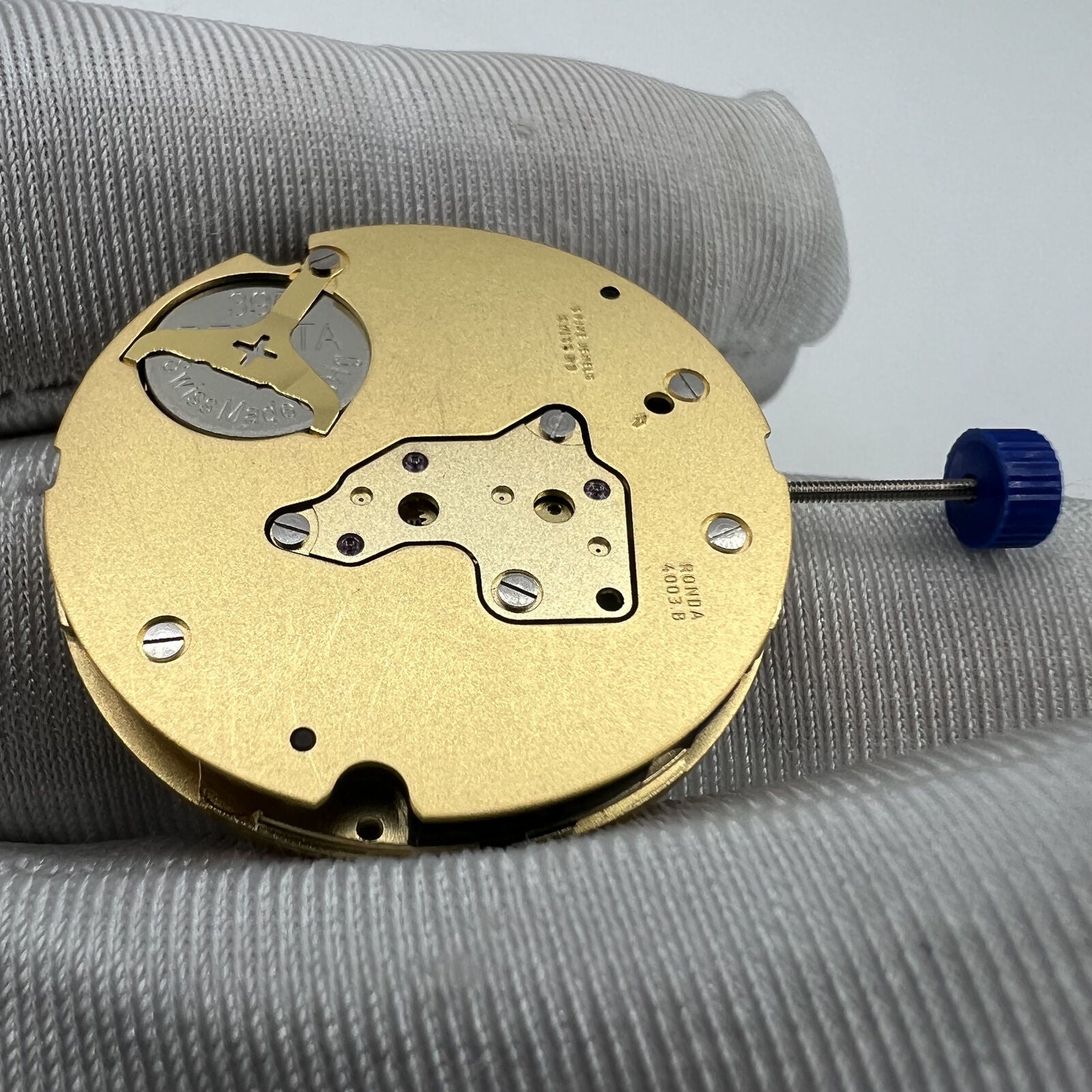 Swiss Ronda 4003B quartz watch movement with date at 12, precision Swiss brand accessory.