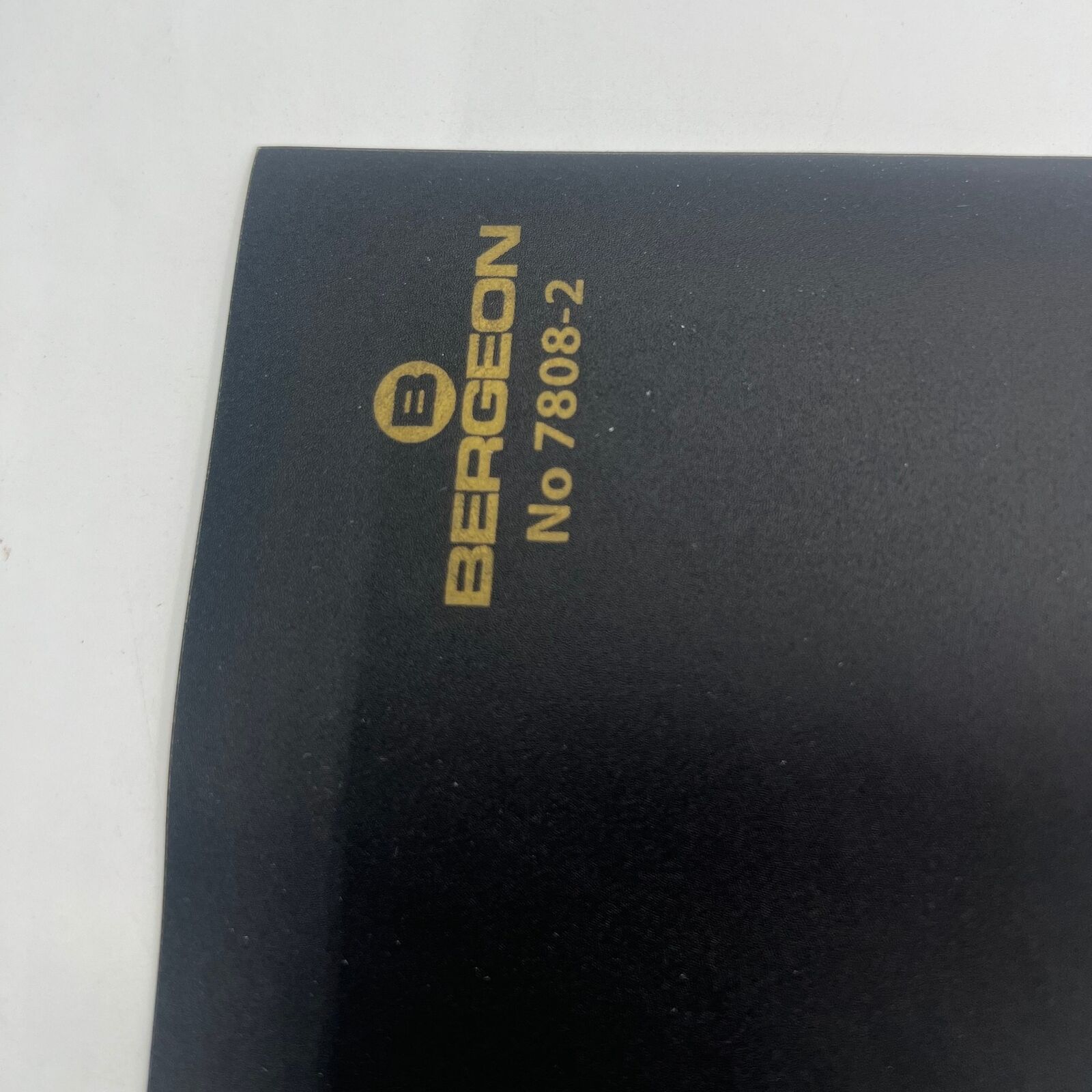 Bergeon 7808-N-01 black anti-skid bench mat, 320x240x2mm, protecting watch repair workspace surface.