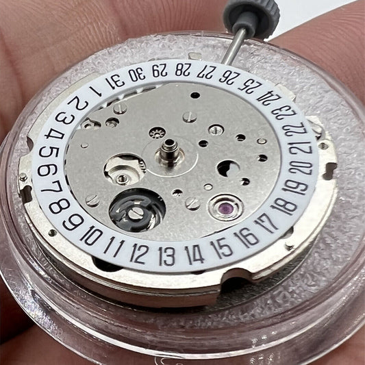 Close-up of Miyota/Citizen 8215 silver plated automatic watch movement with date at 6, Japan-made craftsmanship.
