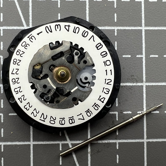 Hattori Epson TMI VX12 quartz watch movement with date at 3, Japan-made precision parts.