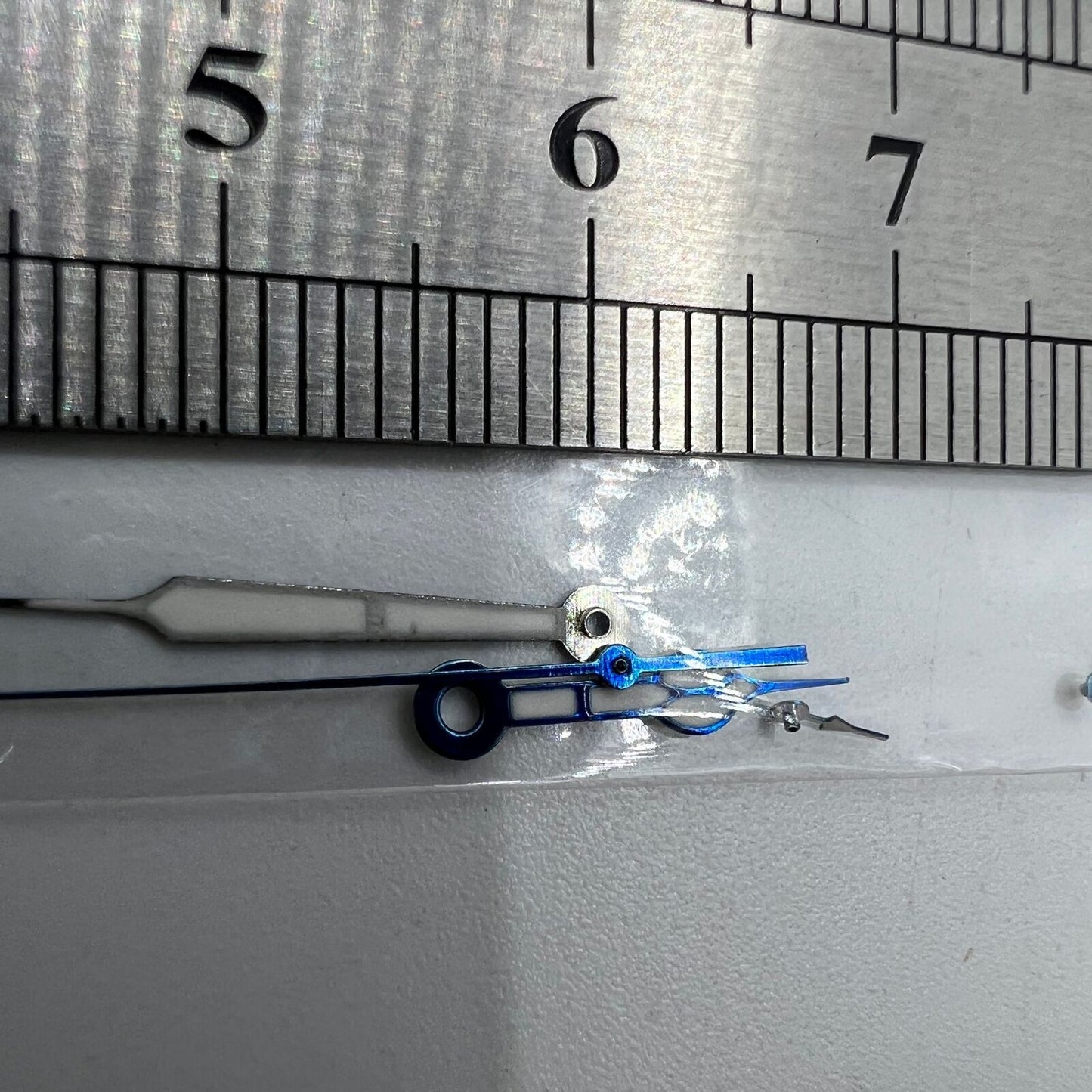 Blue-trimmed green lume watch hands compatible with Miyota OS10 and 0S10 movements for clear time reading.