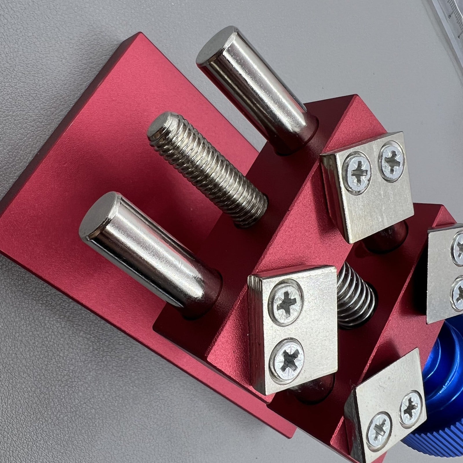 Professional watch bezel remover and case back opener tool for precise watch repair workbench.