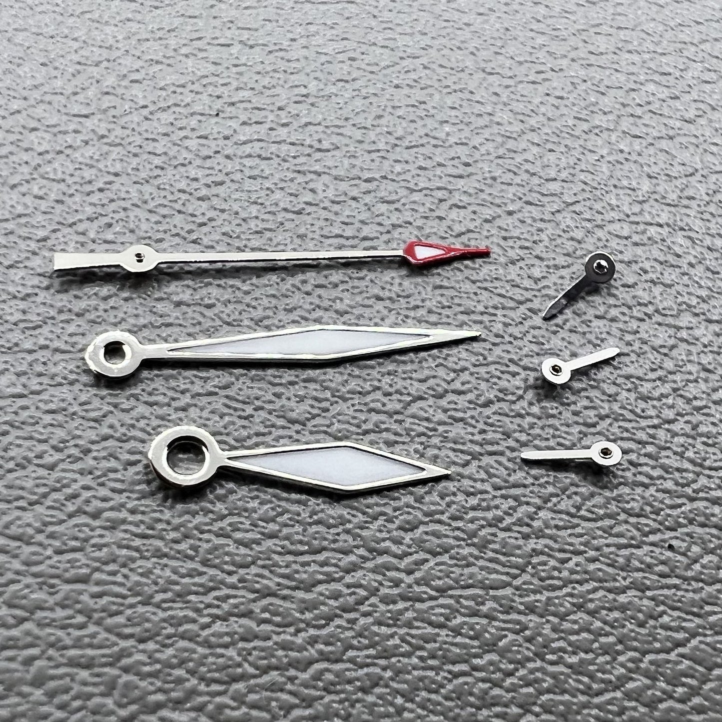 Set of 2 silver diamond-shaped lume hands with trim for Miyota JS15 watch.