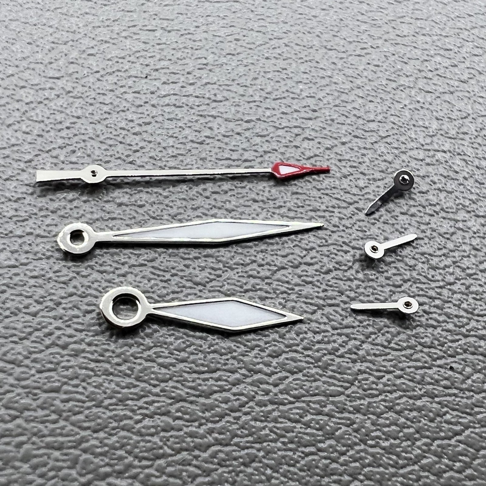 Set of 2 silver diamond-shaped lume hands with trim for Miyota JS15 watch.