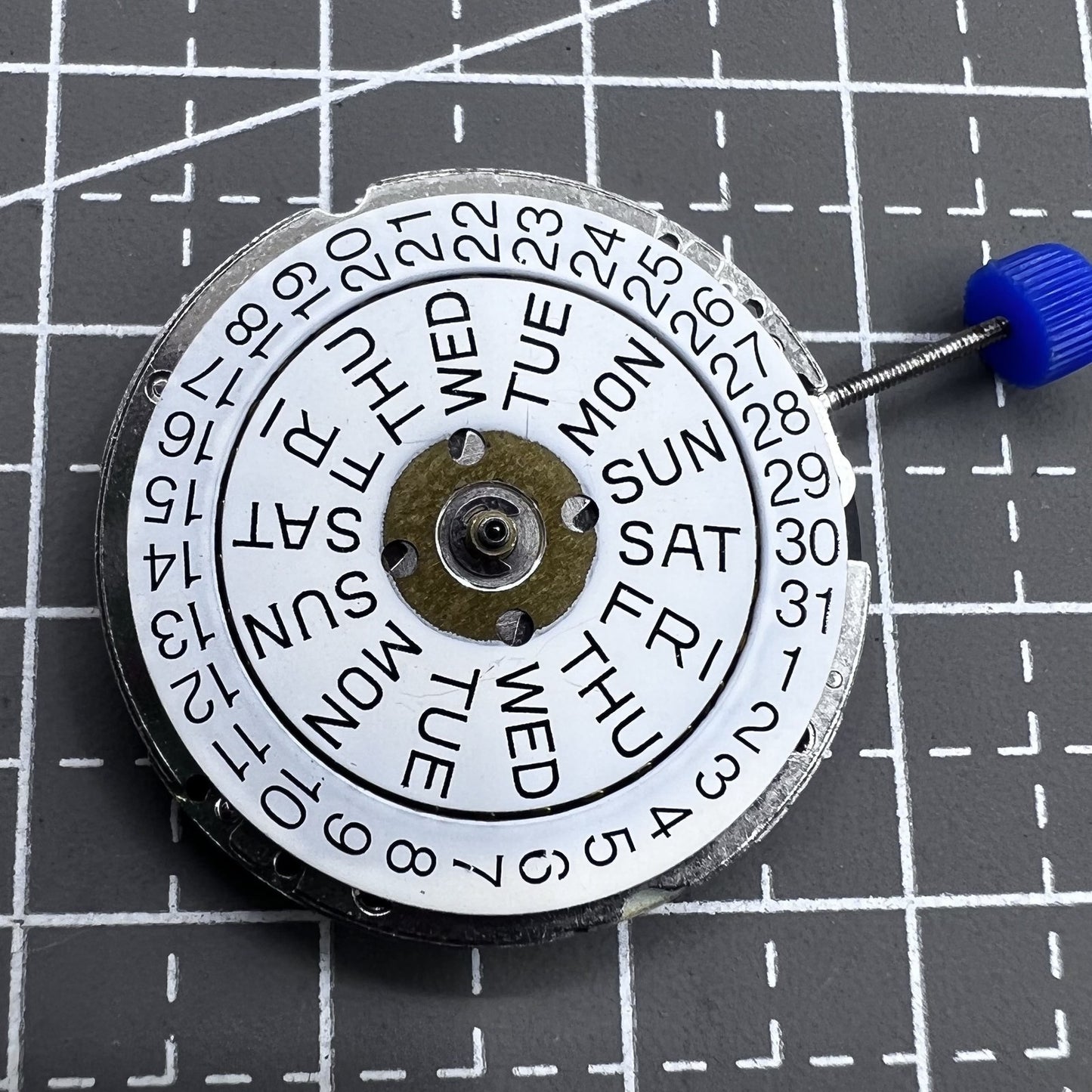 Swiss ISA 1198 quartz watch movement with 3 hands and English day-date display for precise timekeeping.