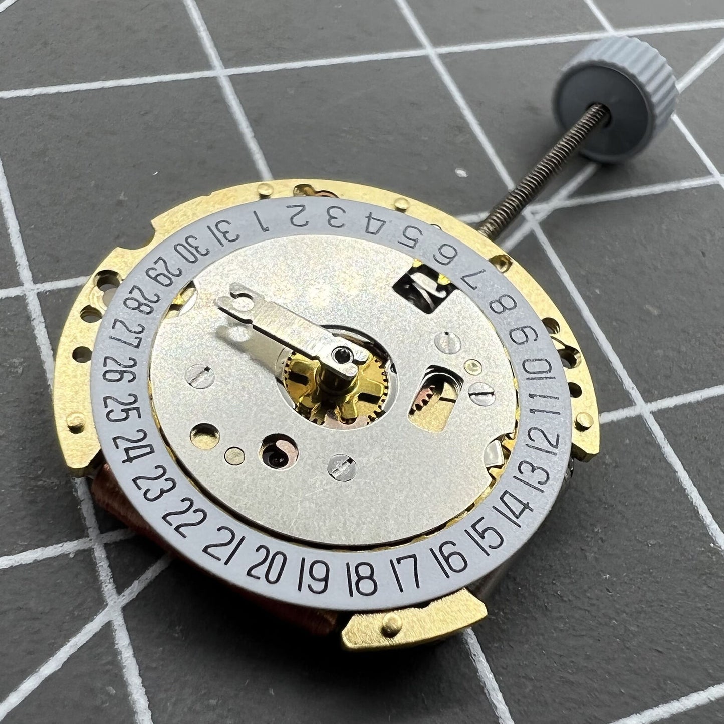 Swiss Made Ronda 775 golden quartz watch movement with date at 6, perfect for Swiss watch brands.