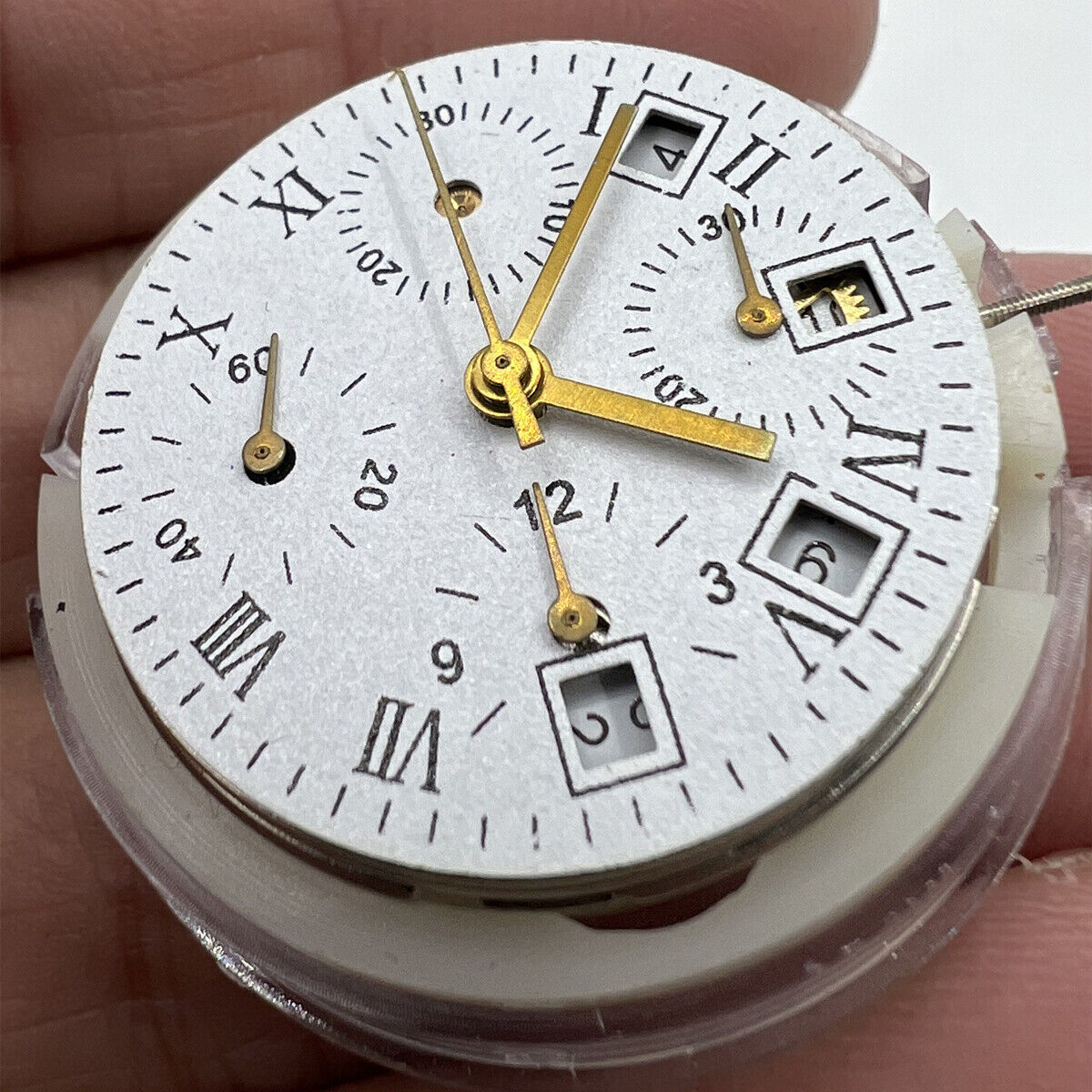 Asian 7750 automatic chronograph movement showing white calendar at 4:30 and seconds subdial at 9, precise timekeeping components.