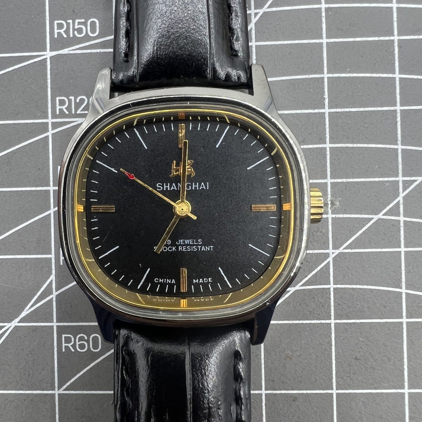 Shanghai Factory 34mm manual mechanical watch with black dial, 19 jewels, shock-resistant, classic timepiece.