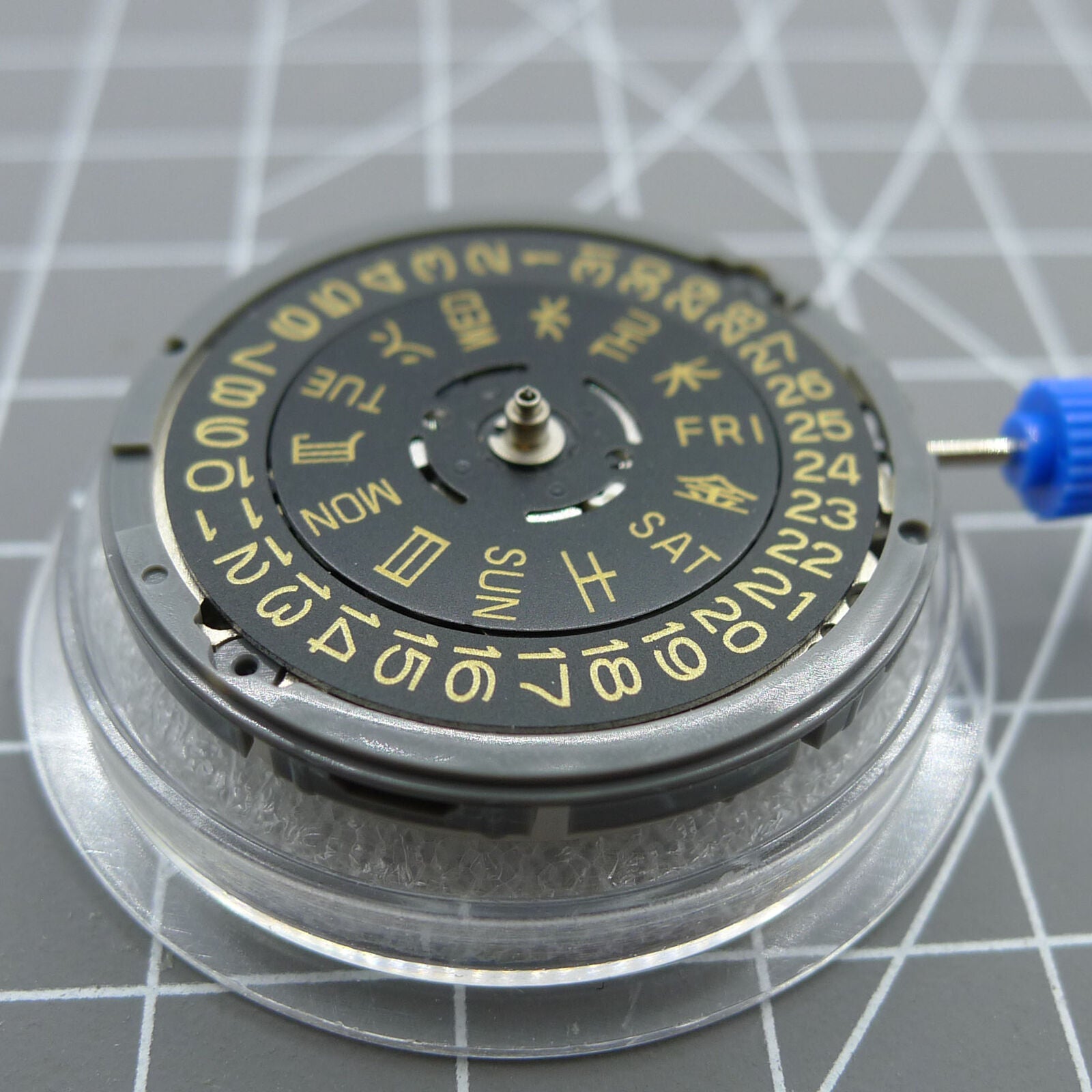 Seiko NH36 automatic watch with black dial, golden font, and crown positioned at 3:00/3:38.