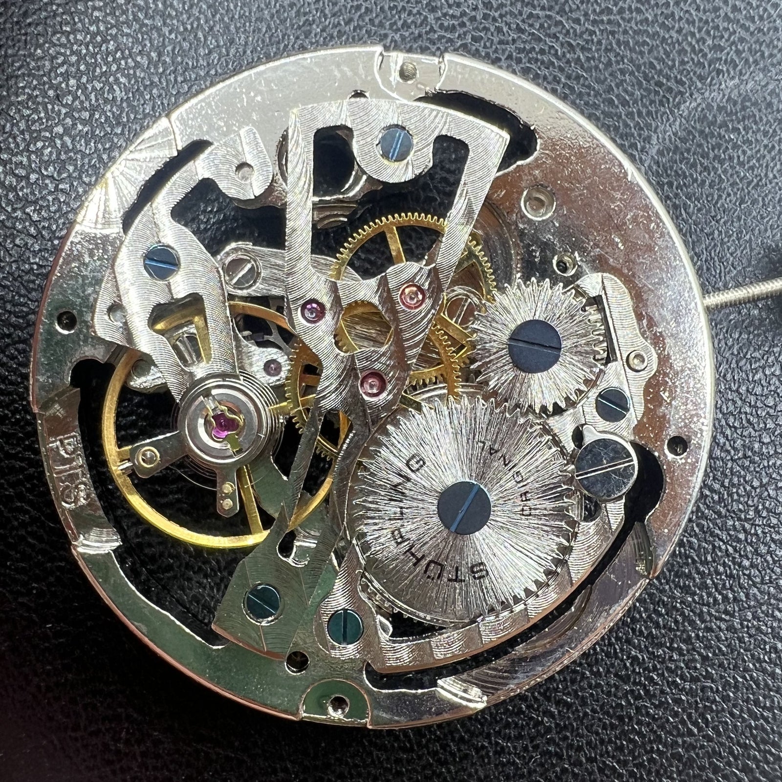 Hollow silver manual winding watch movement, highlighting intricate mechanical craftsmanship.