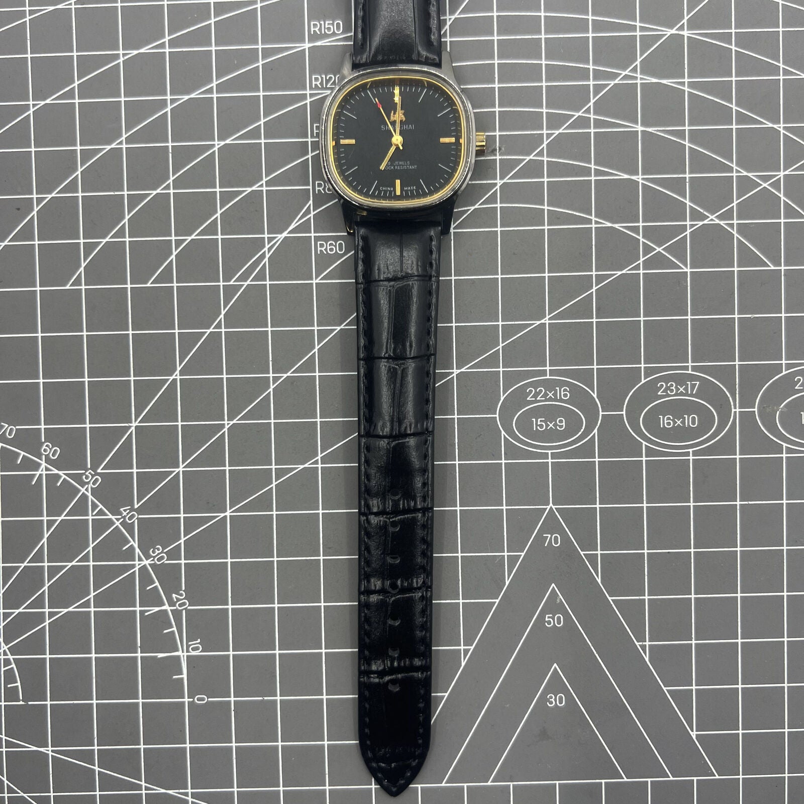 Shanghai Factory 34mm manual mechanical watch with black dial, 19 jewels, shock-resistant for daily wear.