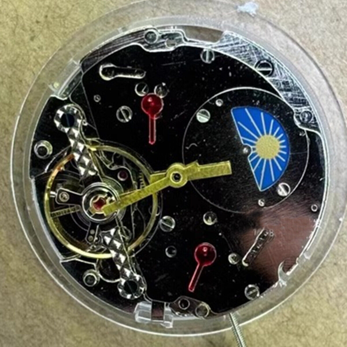 China made multifunctional automatic mechanical watch with moon phase at 12 o'clock, sleek design.