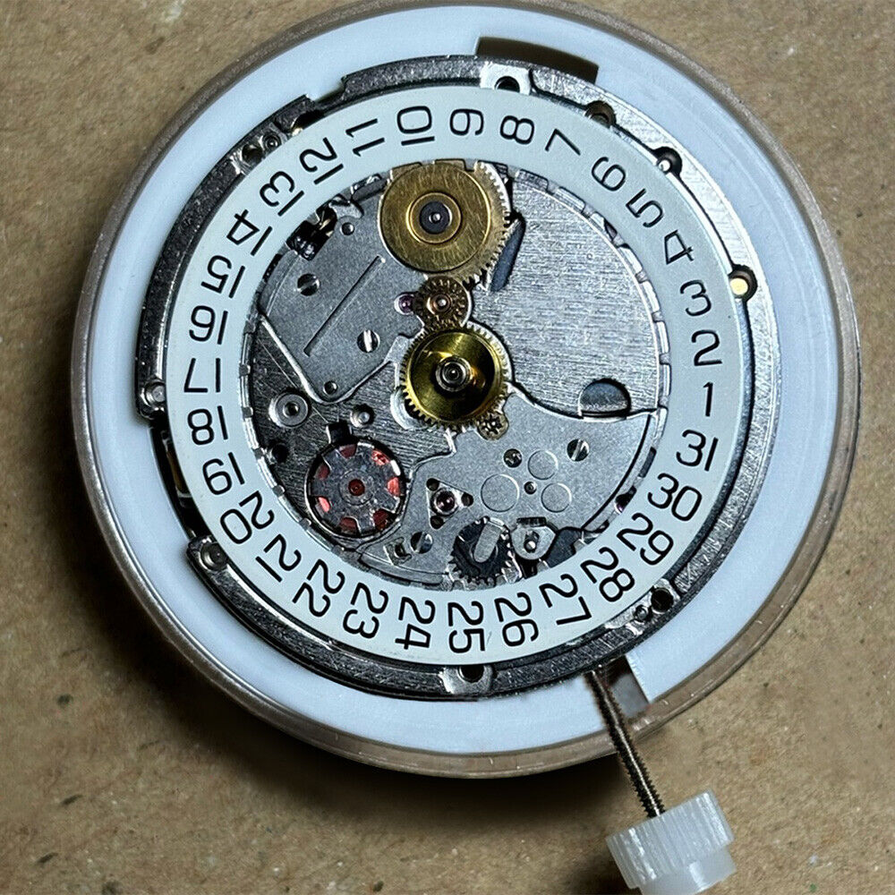 Swiss Made ETA 205.111 watch movement with silver finish, kinetic energy mechanism for precision timekeeping.