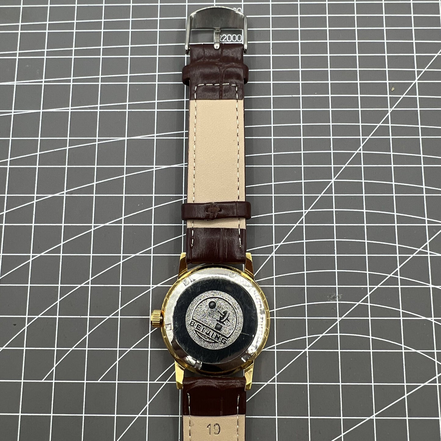 Beijing Double Rhomb mechanical watch with golden case, silver nail markers, and elegant classic design