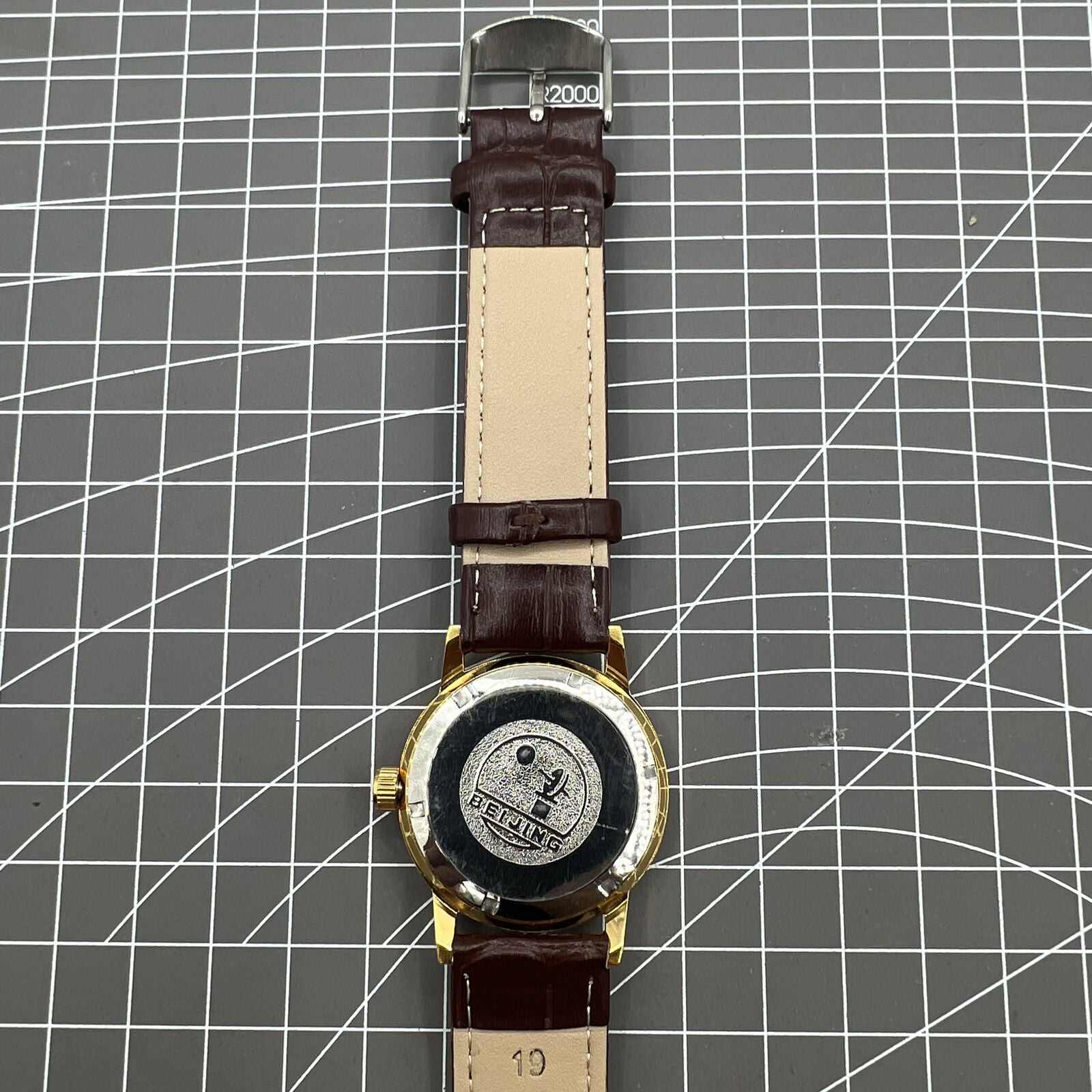 Beijing Double Rhomb mechanical watch with golden case, silver nail markers, and elegant classic design