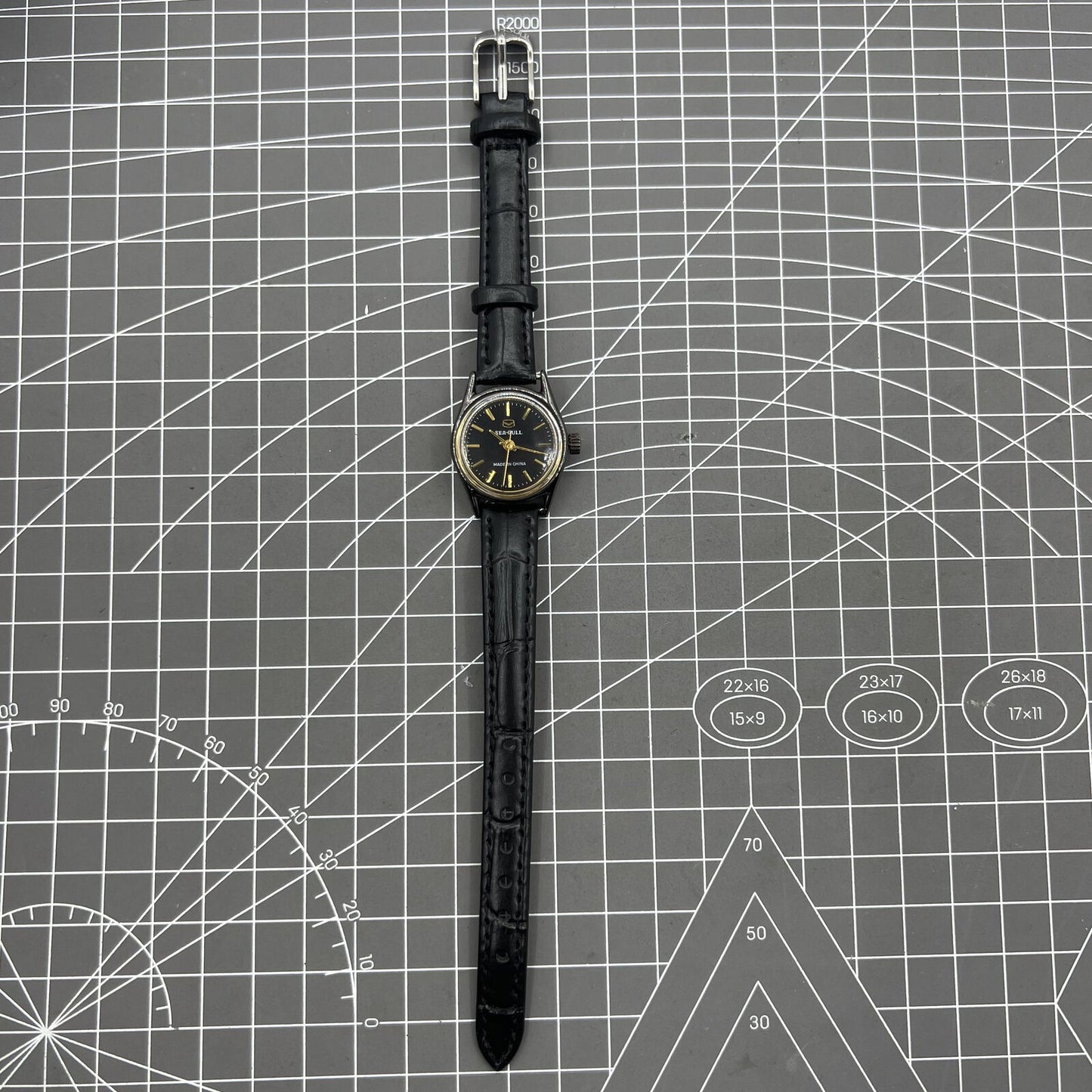 27mm Tianjin Seagull ladies watch with manual mechanical movement and golden nail hour markers.