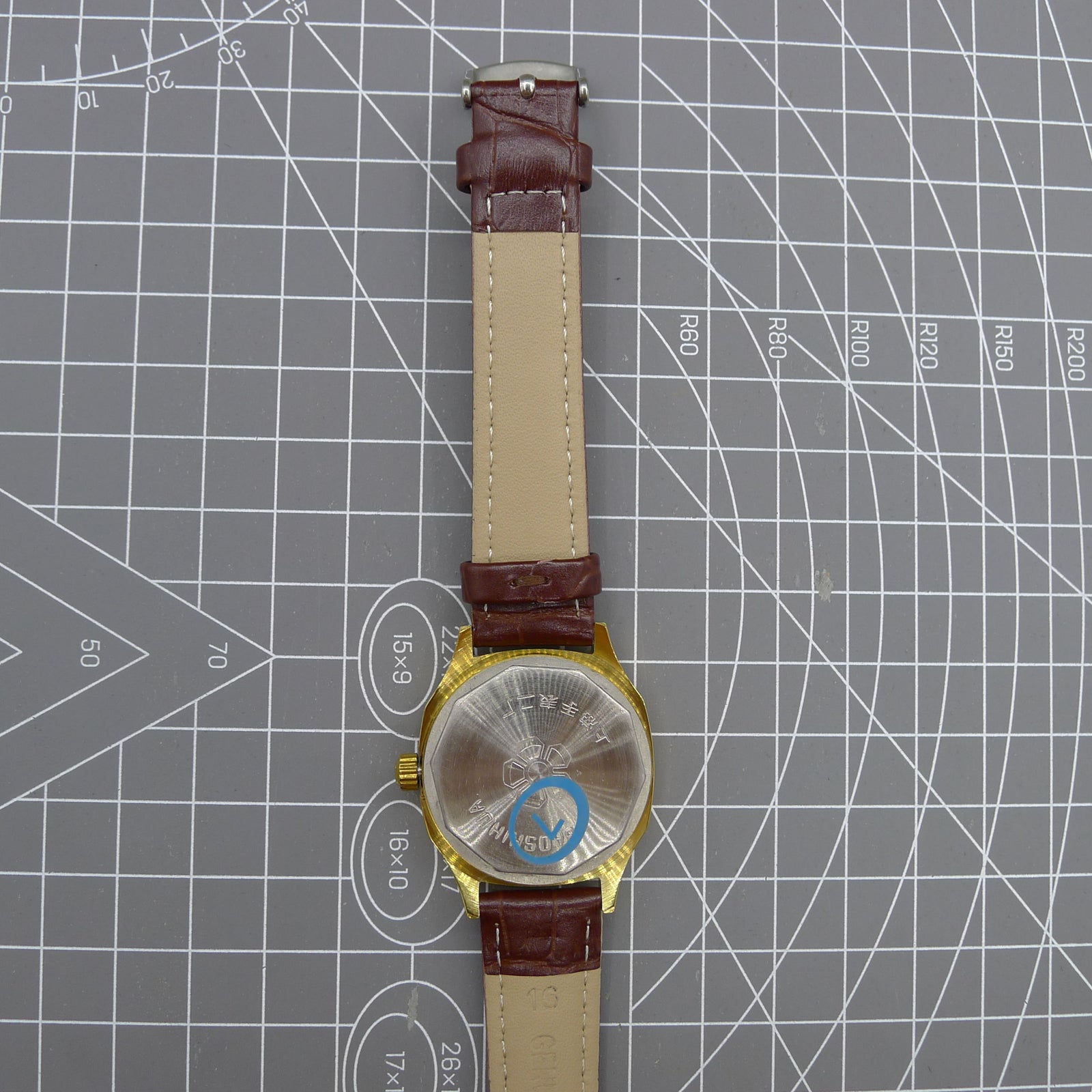 Shanghai 33mm manual mechanical watch with blue dial, golden markers, square case, 17 jewels movement.