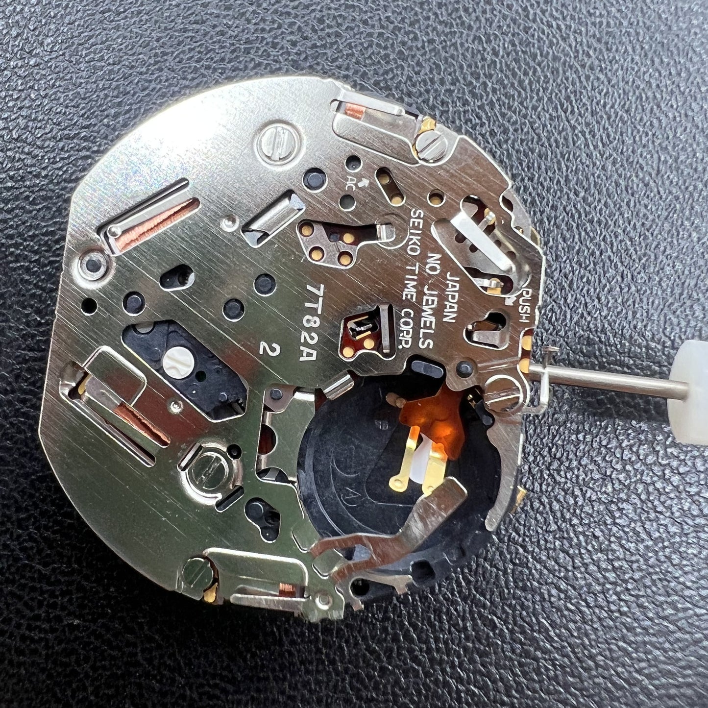 Seiko 7T82A quartz movement close-up showing precision Japanese watch mechanism.