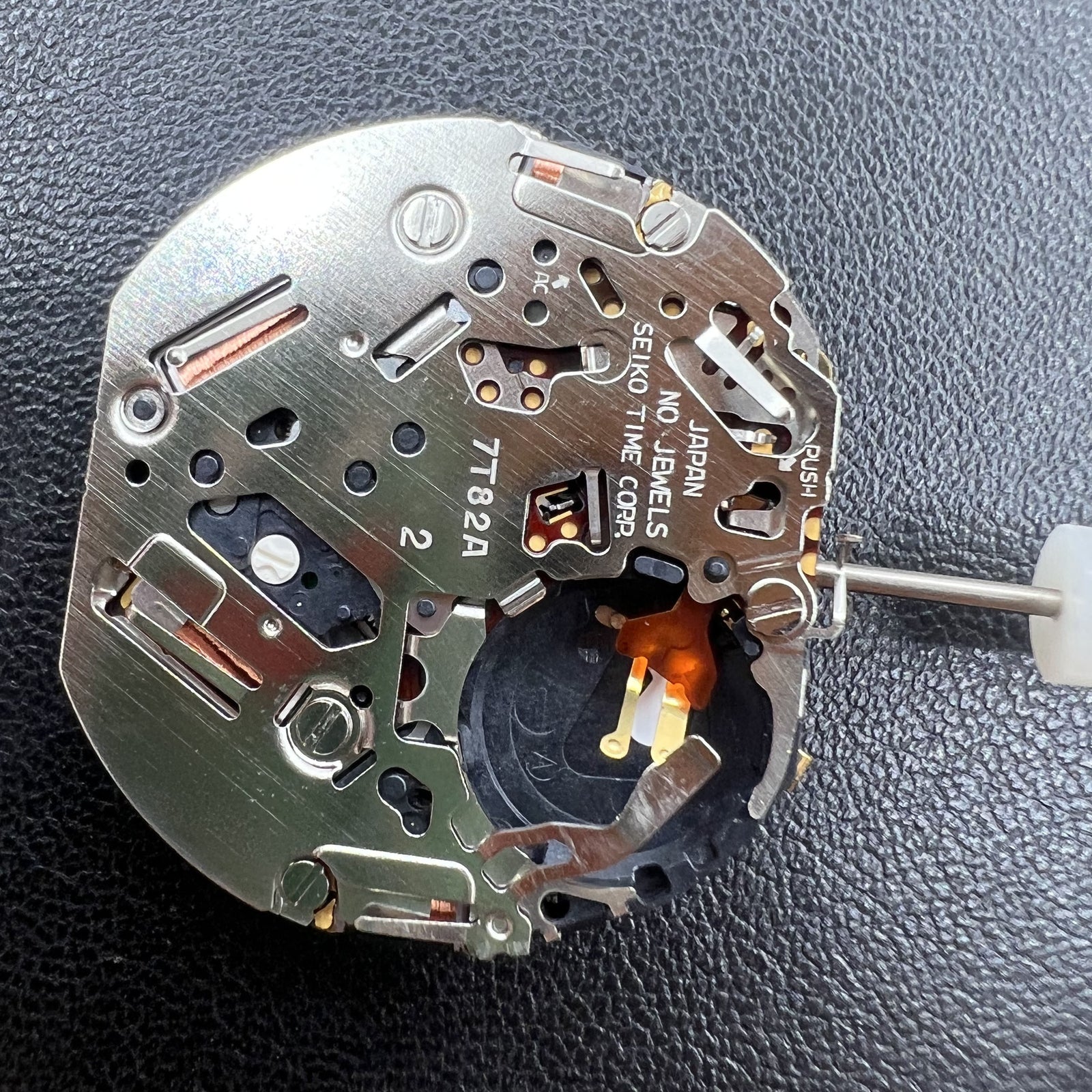 Seiko 7T82A quartz movement close-up showing precision Japanese watch mechanism.