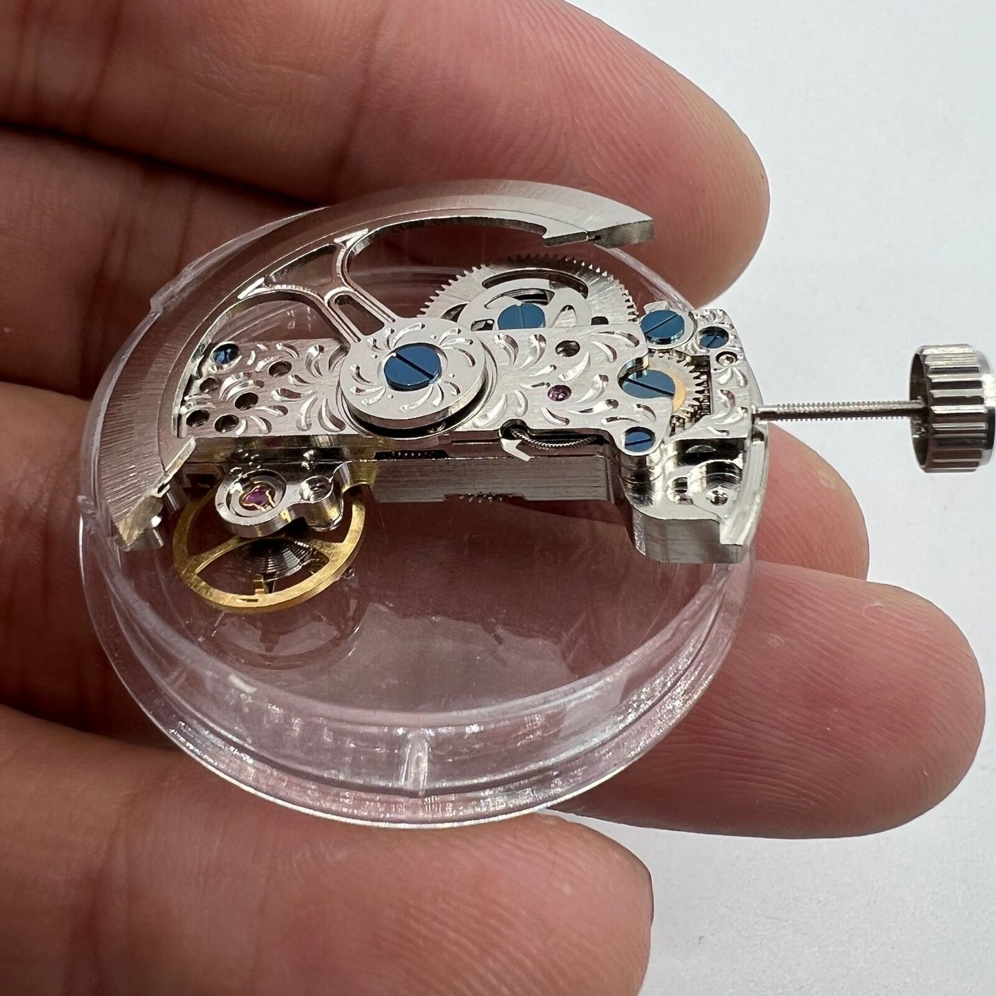 Silver long pendulum wheel watch accessory by Asian with visible automatic mechanical movement details