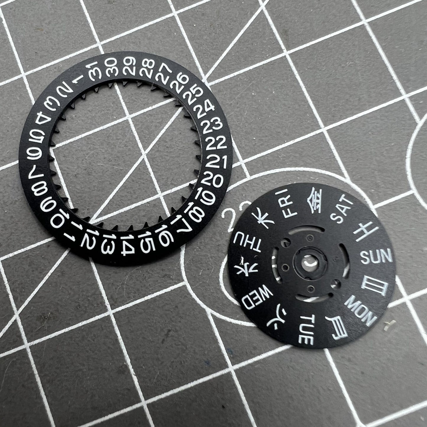 Blue Lume black date and week disk wheel for NH36 movement, enhancing precision in Seiko watch accessories.