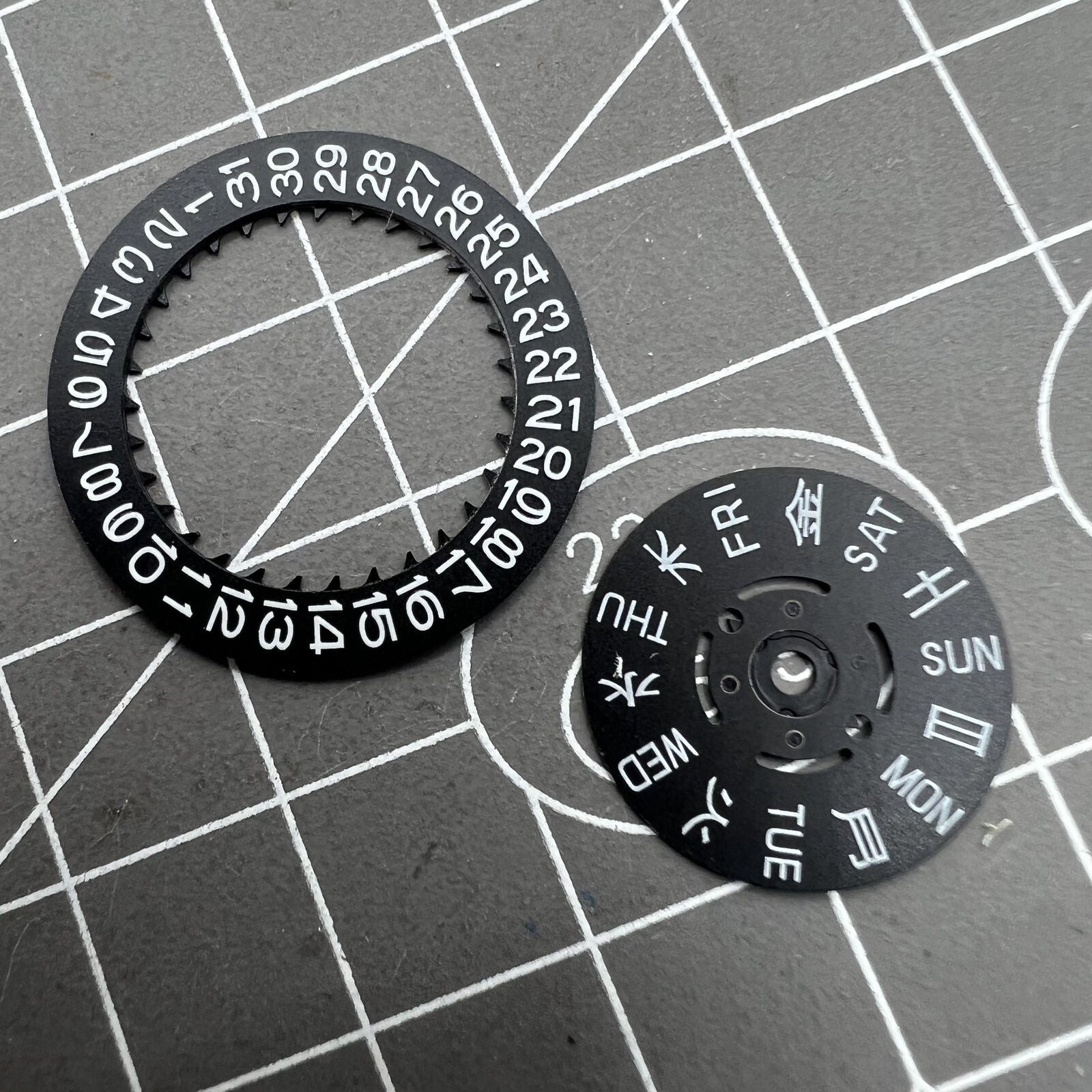 Blue Lume black date and week disk wheel for NH36 movement, enhancing precision in Seiko watch accessories.