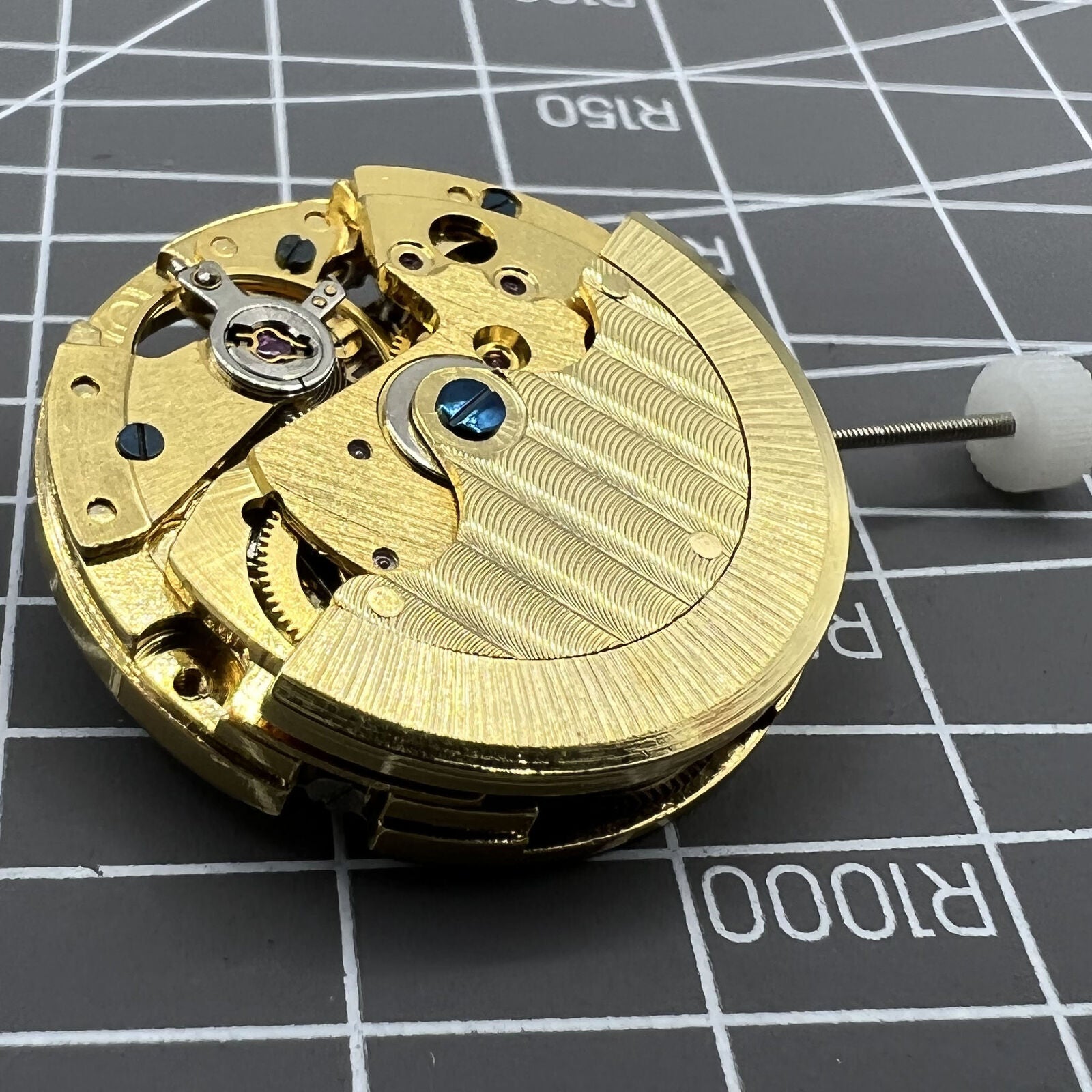 Generic 8205 mechanical watch movement showcasing skeleton dial, star phase, and small seconds at 5 o?clock for precise timekeeping.