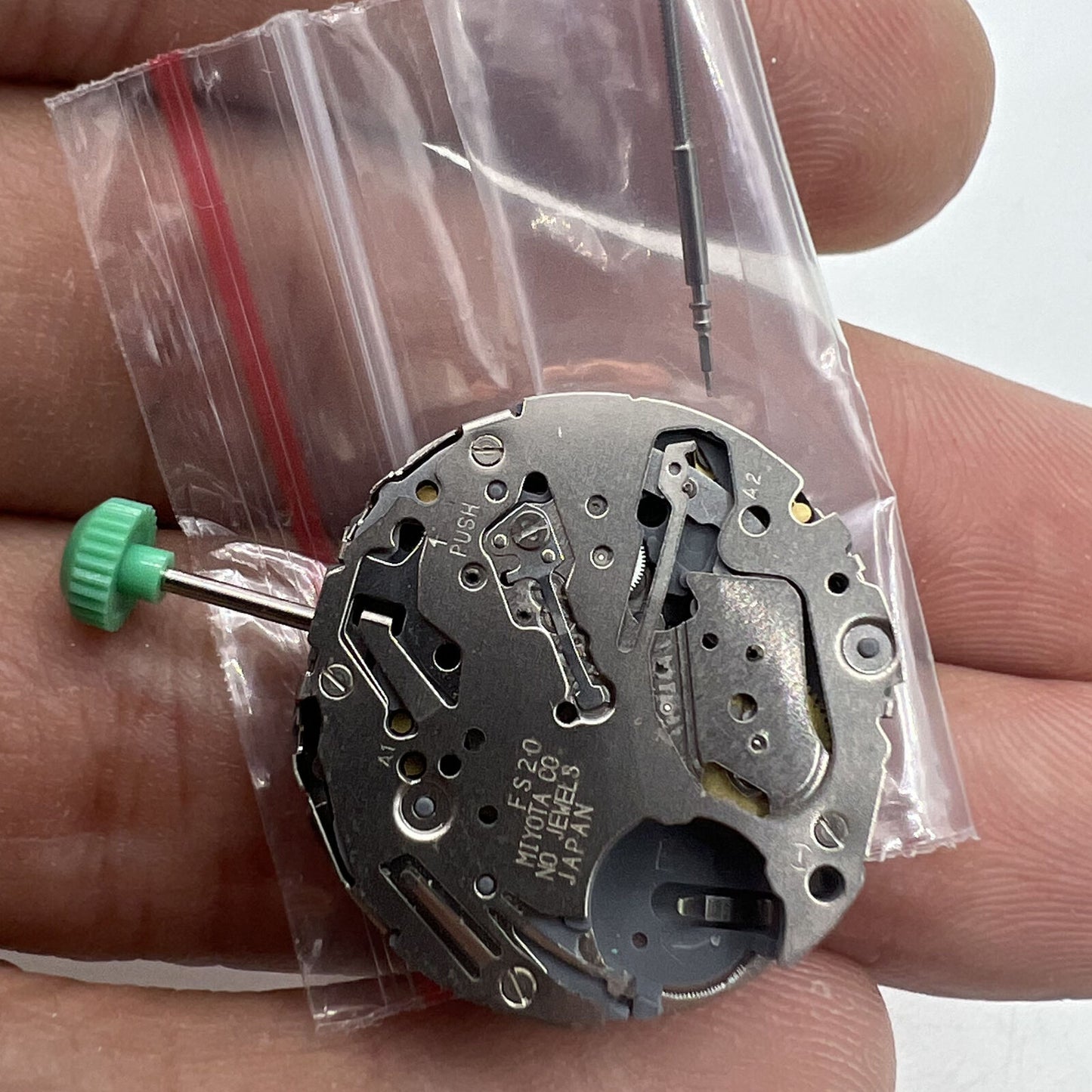 Miyota FS20 chronograph quartz watch movement with date window at 3 o'clock, Japan-made precision by Miyota.