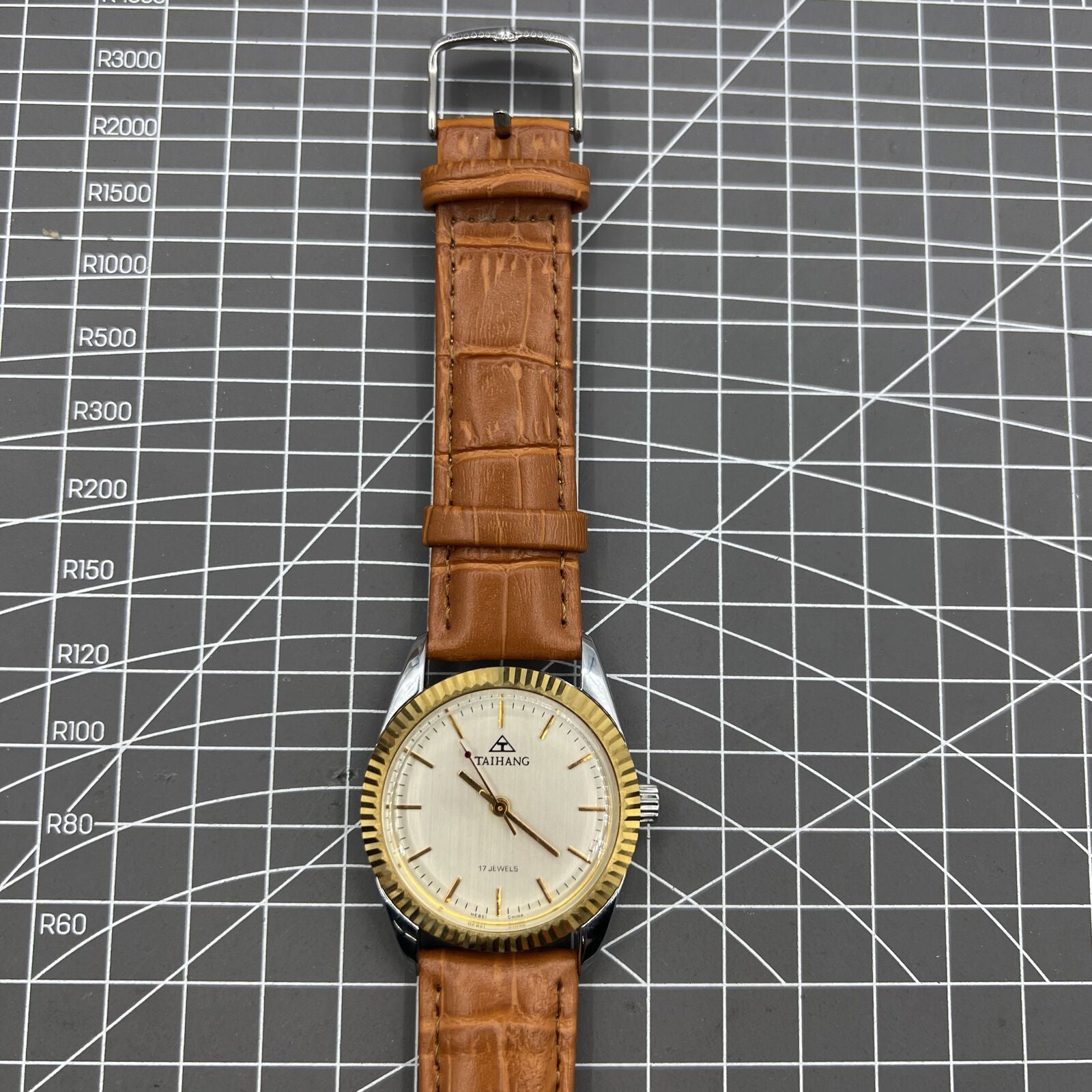 TAIHANG 38mm manual mechanical watch with golden nails, silver dial, and round case, 17 jewels.