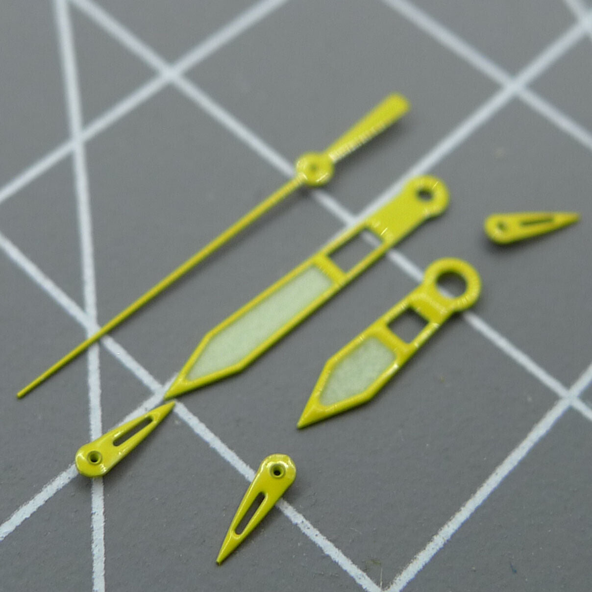 Yellow-trimmed green luminous watch hands for Miyota OS10 movements, precise and stylish accessory.