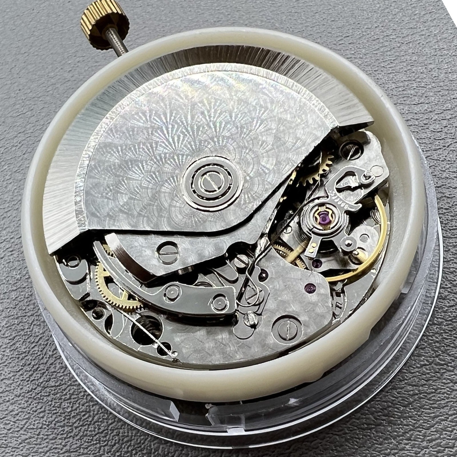 Dandong 7750 mechanical watch movement with single calendar and small second subdials at 6, 9, and 12 o'clock positions