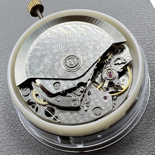Dandong 7750 mechanical watch movement with single calendar and small second subdials at 6, 9, and 12 o'clock positions