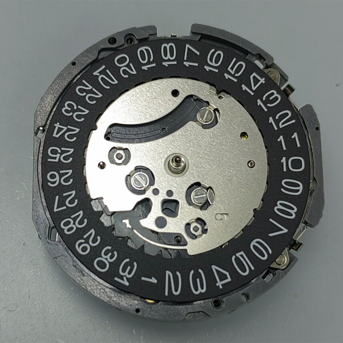 Black disk watch part with Seiko VK63 quartz movement, Japan made, for precise timepiece repair.