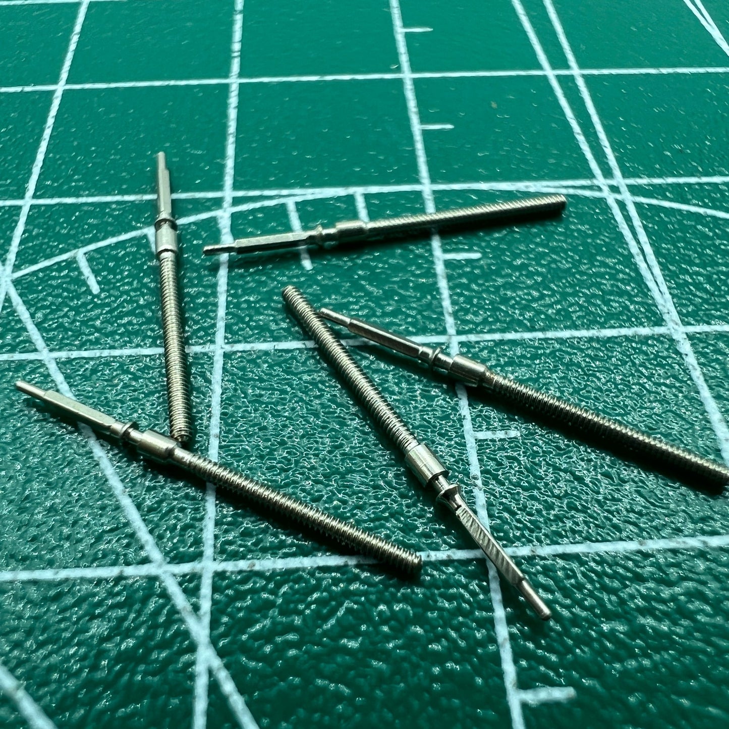 Wholesale lot of watch winding stems for 6309 movement, durable spare parts for watch repairs.