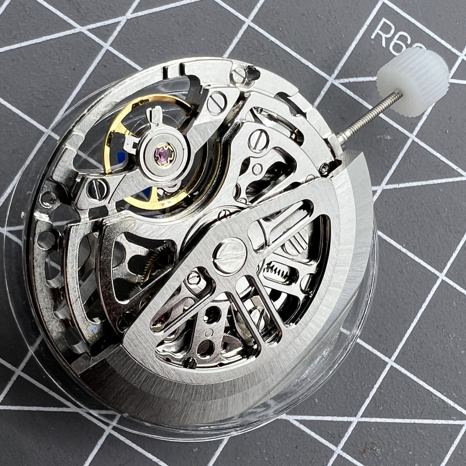 Asian HZ75DOA silver balance wheel highlighting automatic mechanical movement in a watch accessory.