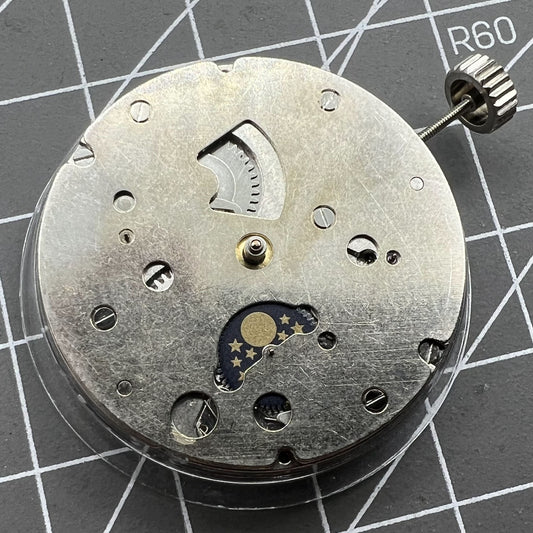 Close-up of China Made Hangzhou automatic kinetic watch with small second at 4 and no rotor, showcasing precise movement.